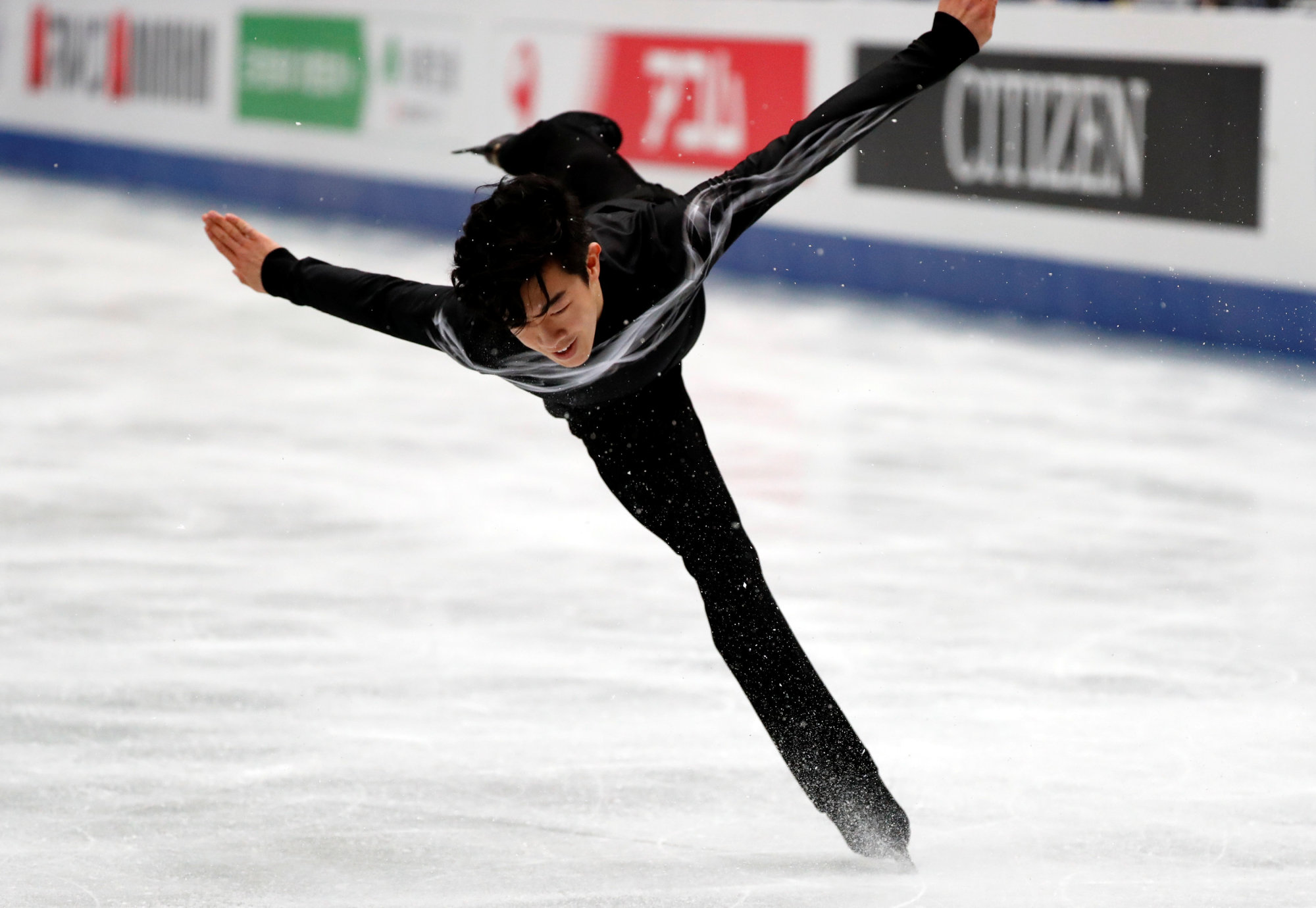 Nathan Chen competes to 'Land of All' in the men's free skate at the World Figure Skating Championships on Saturday night at Saitama Super Arena. Chen retained his title with 323.42 points. | REUTERS