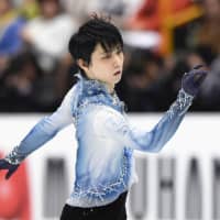 Two-time Olympic champion Yuzuru Hanyu performs his short program at the world championships on Thursday. Hanyu is in third place with 94.87 points. | KYODO