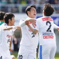 Kawasaki\'s Kei Chinen (center) celebrates after scoring his team\'s opening goal against Matsumoto on Sunday in Matsumoto, Nagano Prefecture. | KYODO