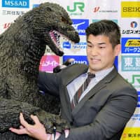 Japan men\'s national team judo coach Kosei Inoue stands next to an actor dressed as Godzilla at a Tuesday news conference. The All Japan Judo Federation has given its national team the nickname \"Godzilla Japan,\" it was announced on the same day. | KYODO