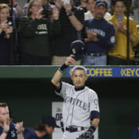 Seattle Mariners outfielder Ichiro Suzuki waves to spectators while leaving the field for a defensive substitution in the eighth inning on Thursday at Tokyo Dome. It was his 2,653rd and final game in the majors. | AP