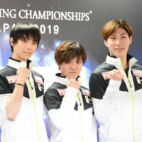 Yuzuru Hanyu (left), Shoma Uno (center), and Keiji Tanaka pose at a news conference Tuesday in Saitama ahead of the 2019 ISU World Championships. | DAN ORLOWITZ