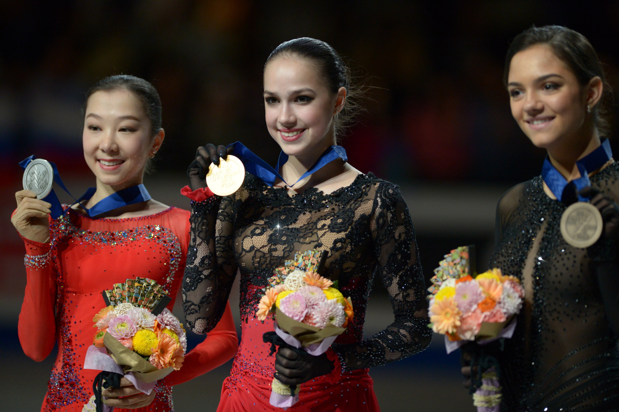 Elizabet Tursynbaeva (left), Alina Zagitova (center) and Evgenia Medvedeva pose with their world championship medals and bouquets Friday at Saitama Super Arena.