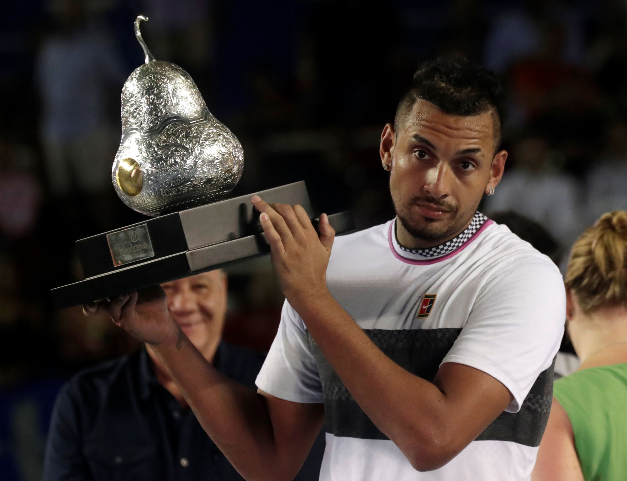 Nick Kyrgios holds the trophy after winning the Mexican Open on Sunday. | REUTERS
