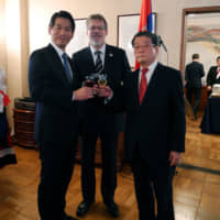 Serbian Ambassador Nenad Glisic (center) poses with Parliamentary Vice-Minister for Foreign Affairs Kenji Yamada (left) and Naohide Ueyama, honorary consul general of Serbia and president of Kincho Dainihon Jochugiku Co., during a reception at the embassy to celebrate Serbia\'s national day on Feb. 15. | EDLEEN OTHMAN