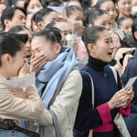 Successful applicants rejoice after hearing results of their highly competitive entrance exam for Takarazuka Music School in Takarazuka, Hyogo Prefecture, on Thursday. The 40 young women admitted to the school will receive training for two years in order to become a member of the famous all-female acting troupe. | KYODO