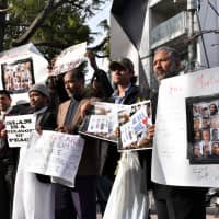 Muslim residents in Japan gather at a park near the New Zealand Embassy in Tokyo\'s Shibuya Ward on Tuesday to offer prayers to victims of the mass shooting in Christchurch last week and to protest against terrorist attacks. | SATOKO KAWASAKI