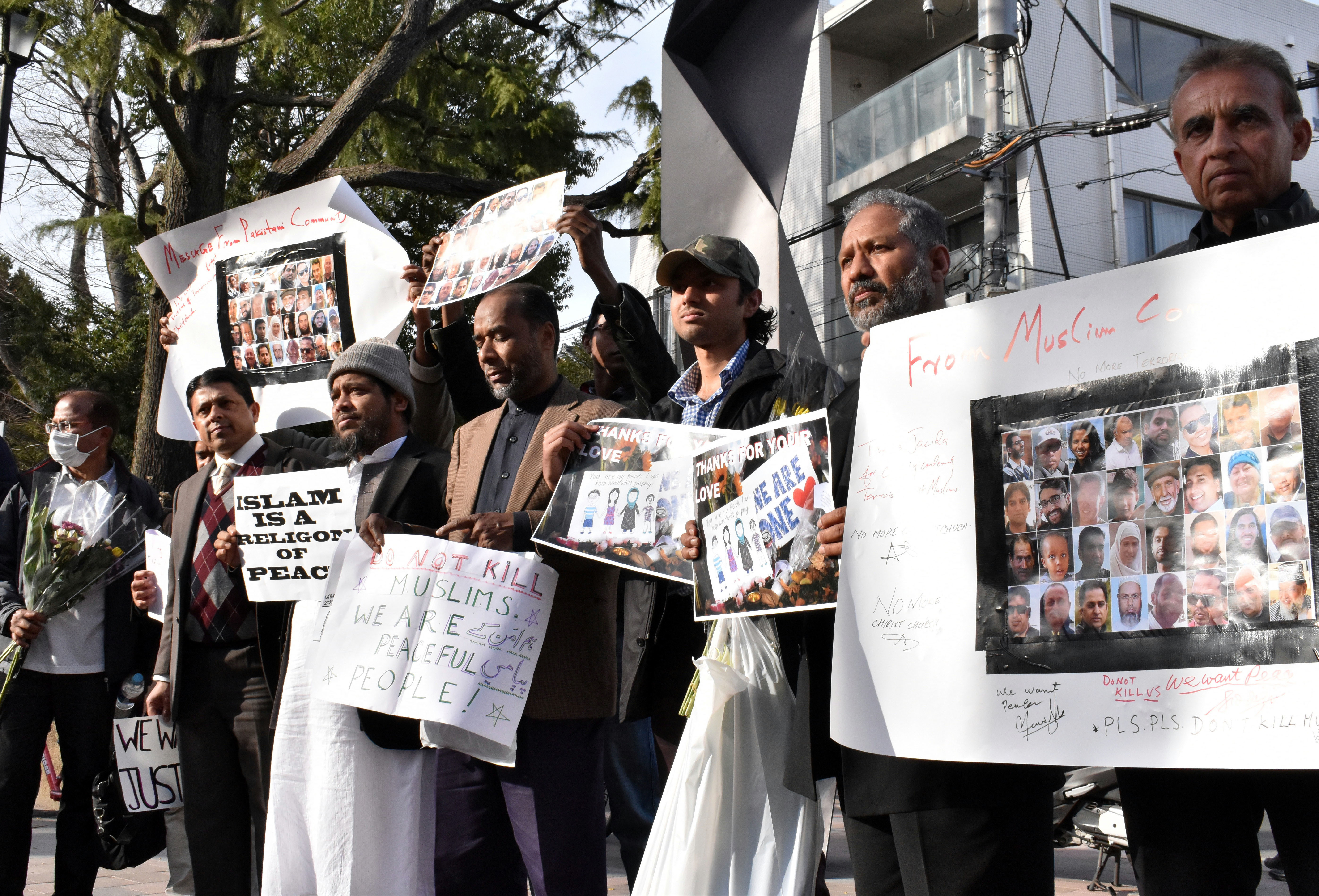 Muslim residents in Japan gather at a park near the New Zealand Embassy in Tokyo's Shibuya Ward on Tuesday to offer prayers to victims of the mass shooting in Christchurch last week and to protest against terrorist attacks. | SATOKO KAWASAKI