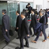Transport ministry officials enter a Japan Airlines Co. office at Haneda airport in Tokyo in November. | KYODO