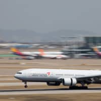 A Boeing Co. 777-200 aircraft operated by Asiana Airlines Inc. lands at Incheon International Airport in South Korea on Monday. | BLOOMBERG