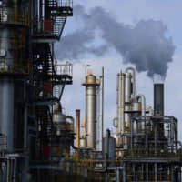 Steam rises from a plant in the Keihin Industrial Area in Kawasaki. Data released Friday shows the nation’s factory output fell unexpectedly in March, fueling concerns about the country’s economy. | BLOOMBERG