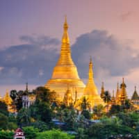 The Shwedagon Pagoda overlooks Yangon at dusk. | GETTY IMAGES