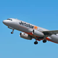 An aircraft belonging to Jetstar Japan Co. Ltd., in which Japan Airlines Co. holds a stake, flies last month. | KYODO