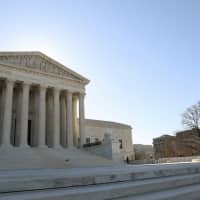 The U.S. Supreme Court building is seen in Washington on March 26. The top U.S. court agreed Monday it would decide whether the Civil Rights Act of 1964 law that bans workplace discrimination on the basis of sex protects gay and transgender workers. | REUTERS