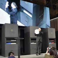 Shinichi Sakane, president of Seven Dreamers Laboratories Inc., introduces its Laundroid machine at the annual Combined Exhibition of Advanced Technologies, or CEATEC, at Makuhari Messe convention center in Chiba in October 2016. | KYODO
