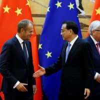 European Council President Donald Tusk, Chinese Premier Li Keqiang (center) and European Commission President Jean-Claude Juncker attend a signing ceremony at the Great Hall of the People in Beijing last July. | REUTERS