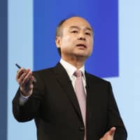 Masayoshi Son, the billionaire founder of SoftBank Group Corp., explains his company\'s earnings for the April-December period at a news conference in Tokyo on Feb. 6. | KYODO