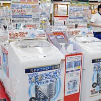 Washing machines are displayed at a store in Tokyo. | KYODO