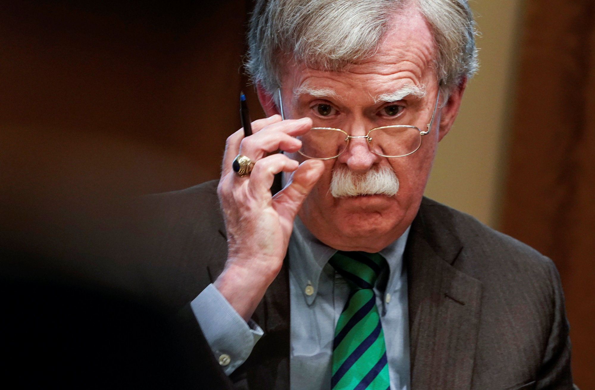 National Security Adviser John Bolton listens as U.S. President Donald Trump speaks while meeting with NATO Secretary General Jens Stoltenberg in the Oval Office at the White House on Tuesday. | REUTERS