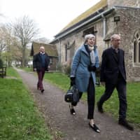 Britain\'s Prime Minister Theresa May and her husband, Philip, leave church near High Wycombe, England, on Sunday. | REUTERS