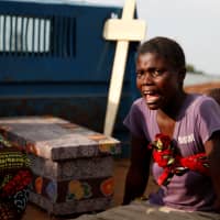 A woman cries during the funeral of a child, suspected of dying from Ebola, next to the coffin in Beni, North Kivu Province of Democratic Republic of Congo, last December. | REUTERS