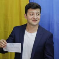 Ukrainian comedian and presidential candidate Volodymyr Zelenskiy shows his ballot before casting his ballot at a polling station during the second round of presidential elections in Kiev on Sunday | AP