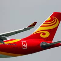 A Hong Kong Airlines jet descends before landing at Hong Kong Airport in April 2018. Recent setbacks underscore how HNA Group, which is engaged in a power struggle over control of Hong Kong Airlines, is still struggling to deal with the fallout of a global acquisition spree that pushed it deep into debt. | REUTERS