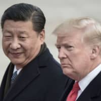 Chinese leader Xi Jinping and U.S. President Donald Trump attend a welcome ceremony at the Great Hall of the People in Beijing in November 2017. | AFP-JIJI