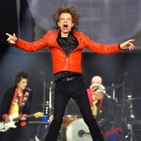 Singer of British band the Rolling Stones Mick Jagger performs with the band during a concert at Berlin\'s Olympic Stadium last June.  Jagger said Saturday he was \"devastated\" after his Rolling Stones were forced to cancel their United States and Canada tour dates so he could receive \"medical treatment.\" | AFP-JIJI
