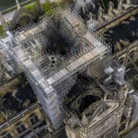 Fire damage to the Notre Dame cathedral in Paris can be seen from the air on Tuesday. | GIGARAMA.RU / VIA AP