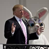 U.S. President Donald Trump speaks from the Truman Balcony during the Easter Egg Roll on the South Lawn of the White House in Washington on Monday. | BLOOMBERG