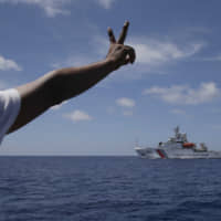 A China Coast Guard vessel attempts to block a Philippine government vessel in March 2014 as the latter tries to enter the China Second Thomas Disputed Shoals, locally known as Ayungin Shoal, for officials to address Philippine troops and deliver provisions. | AP