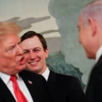 White House senior adviser Jared Kushner smiles as he watches U.S. President Donald Trump (left) talk with Israeli Prime Minister Benjamin Netanyahu at the White House in Washington March 25. | REUTERS
