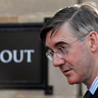 British Conservative Party lawmaker Jacob Rees-Mogg walks outside the Houses of Parliament in London on Wednesday. | REUTERS