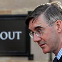 British Conservative Party lawmaker Jacob Rees-Mogg walks outside the Houses of Parliament in London on Wednesday. | REUTERS