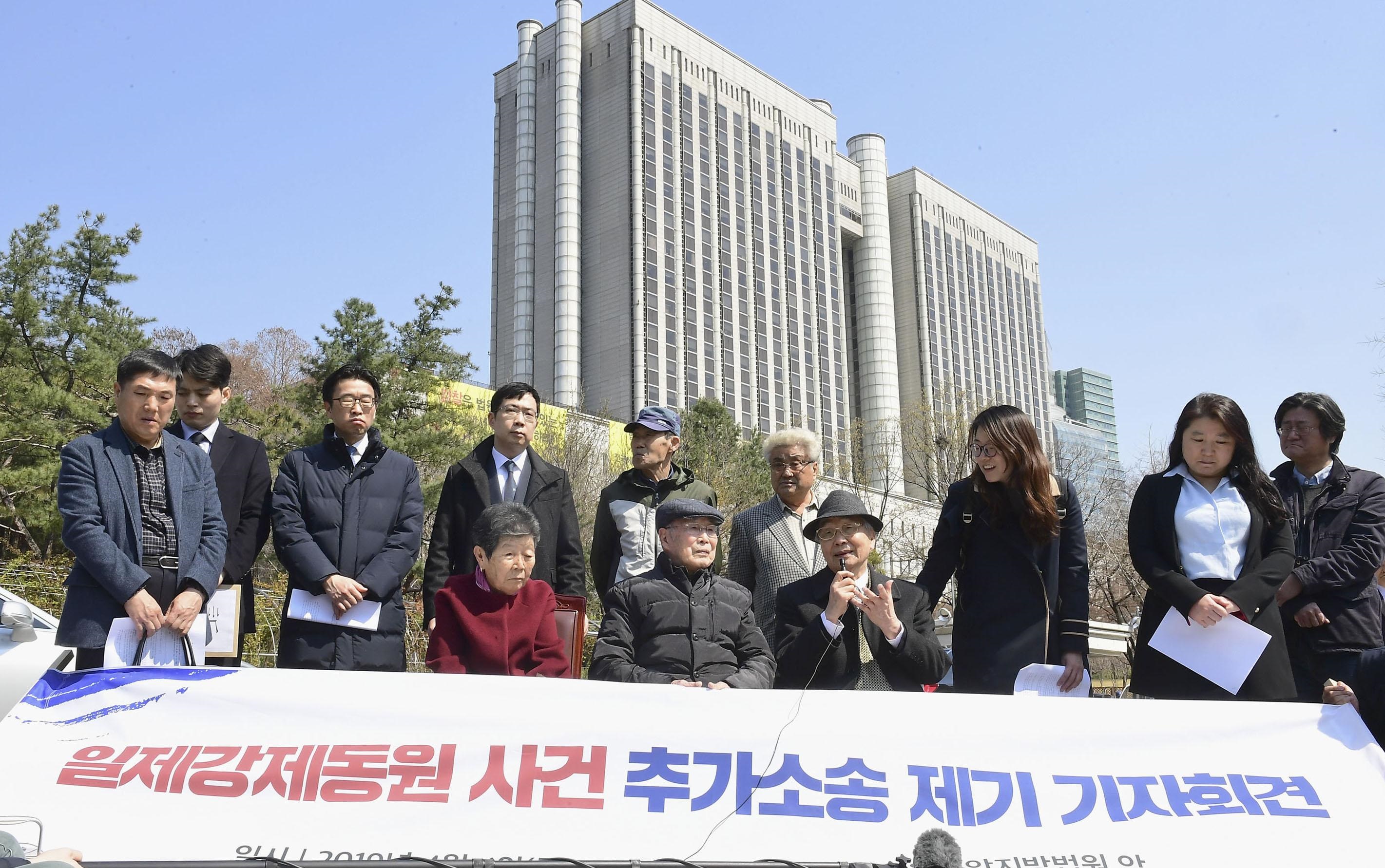 Plaintiffs and lawyers involved with a lawsuit against Japanese firms over wartime labor speak during a news conference Thursday in Seoul. | KYODO