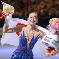 Figure skater Mao Asada celebrates after winning her third world championship in Saitama in March 2014. | KYODO