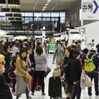 Narita airport\'s departure lobby in Chiba Prefecture is packed with travelers Friday, a day before a 10-day holiday kicked off. | KYODO