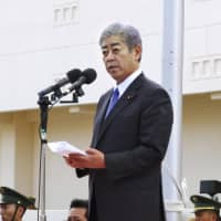 Defense Minister Takeshi Iwaya speaks at a newly opened Ground Self-Defense Force base on Miyako Island on Sunday. | KYODO