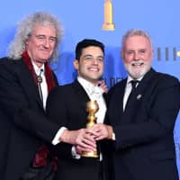 Oscar-winning actor Rami Malek, who played the role of Freddie Mercury in blockbuster movie \"Bohemian Rhapsody,\" joins hands with Queen\'s Brian May and Roger Taylor at the 76th Annual Golden Globe Awards ceremony held in Beverly Hills, California, in January. | GETTY IMAGES