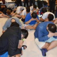 Thai police arrested 15 Japanese on suspicion of working without permission last month in Pattaya. The group is suspected of carrying out a phone scam targeting people in Japan. | KYODO