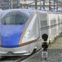 A bullet train passes near Nagano Station. A 77-year-old man is in police custody after allegedly trespassing on shinkansen tracks in the prefecture. | KYODO