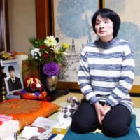Taeko Watanabe, whose son, Yuki, committed suicide in 2008, talks in front of his portrait at her home in Akita Prefecture on Feb. 9. | REUTERS