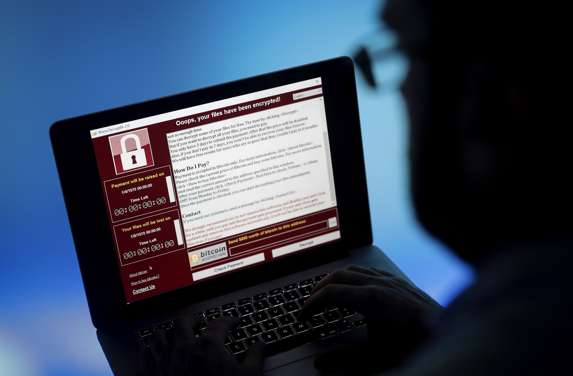 A locked screen from a cyberattack by the Wannacry virus warns that data files have been encrypted on a laptop computer in May 2017. Japan has said it will develop its first-ever computer virus by next March as a defense measure against cyberattacks. | BLOOMBERG