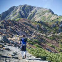 Conquering rugged terrain: A hiker on the approach to the summit of Mount Kita, Japan\'s second tallest mountain. | OSCAR BOYD