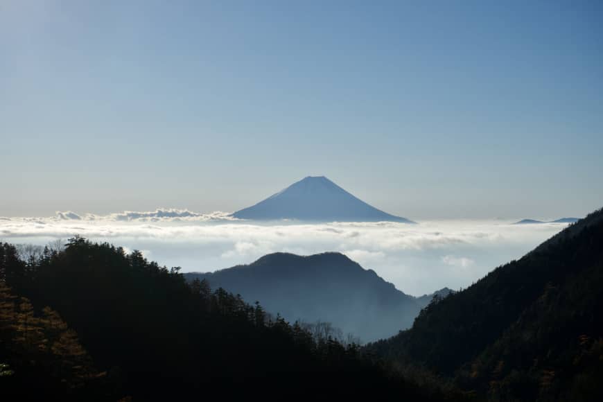 Towering above the cloudline: A view of Mount Fuji from the trail to the summit of Mount Houou in the Southern Alps.