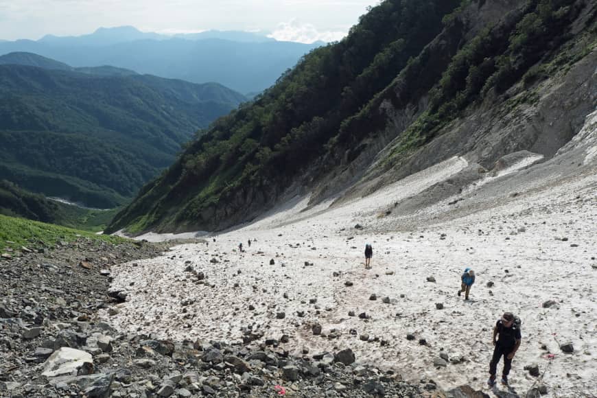 Gear up: Hikers take the exciting approach to the summit of Mount Shirouma via the Daisekkei (Great Snow Valley), a year-round snow field for which simple crampons are recommended.