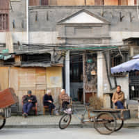 Shanghai hustle: Elderly residents of Shanghai sit out on the street in the shikumen (lane house) district of Xiaonanmen. | MATTHEW WALSH