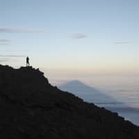 The rewards of the climb: Capturing the morning shadow cast by Mount Fuji on a sea of clouds. | COURTESY OF WES LANG