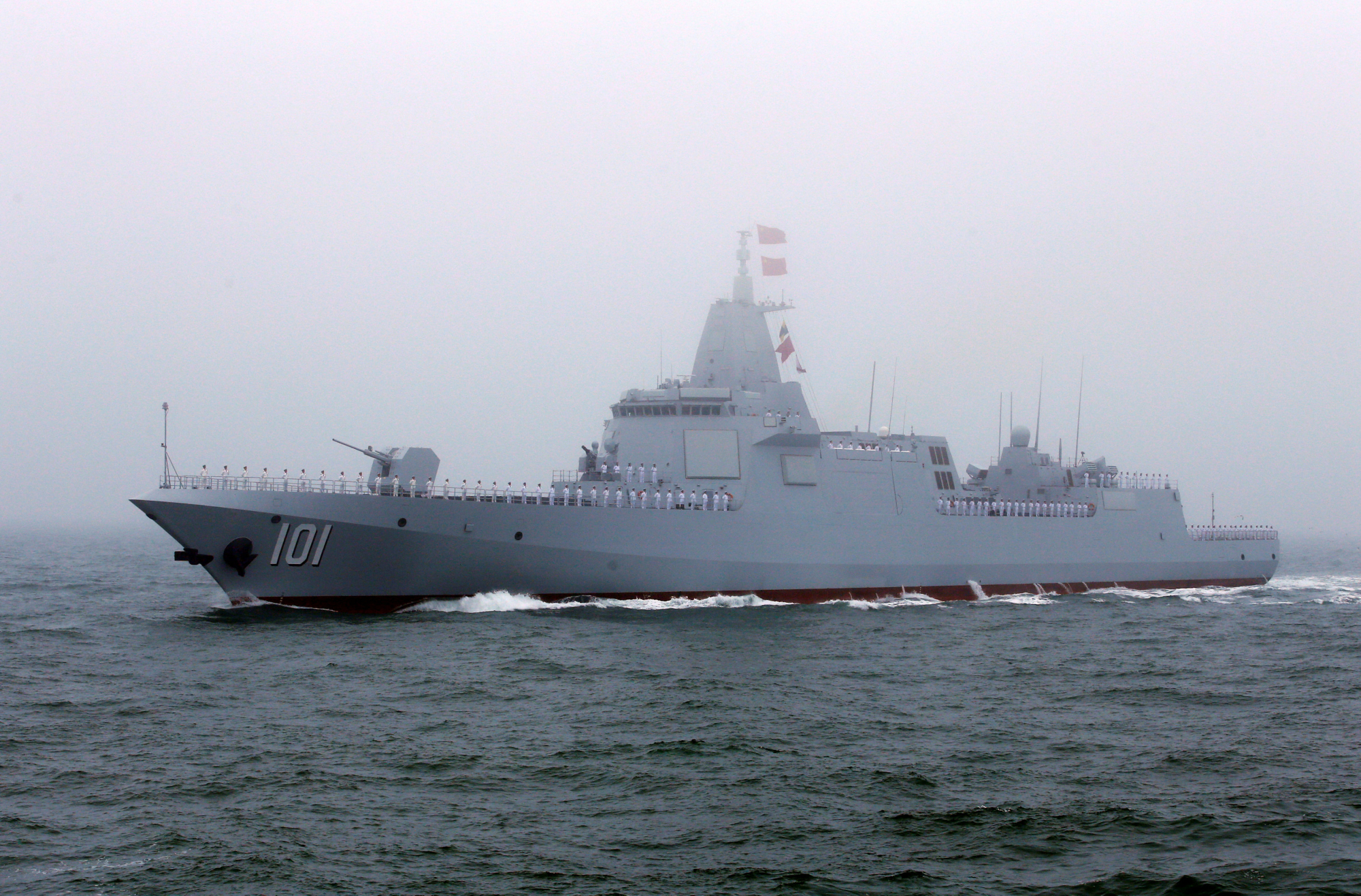 The first of the Chinese Navy's new heavily armed 10,000-ton Type 055 destroyers, the Nanchang, takes part in a naval parade Tuesday off the coast of Qingdao to mark the 70th anniversary of the founding of the People's Liberation Army Navy. | REUTERS